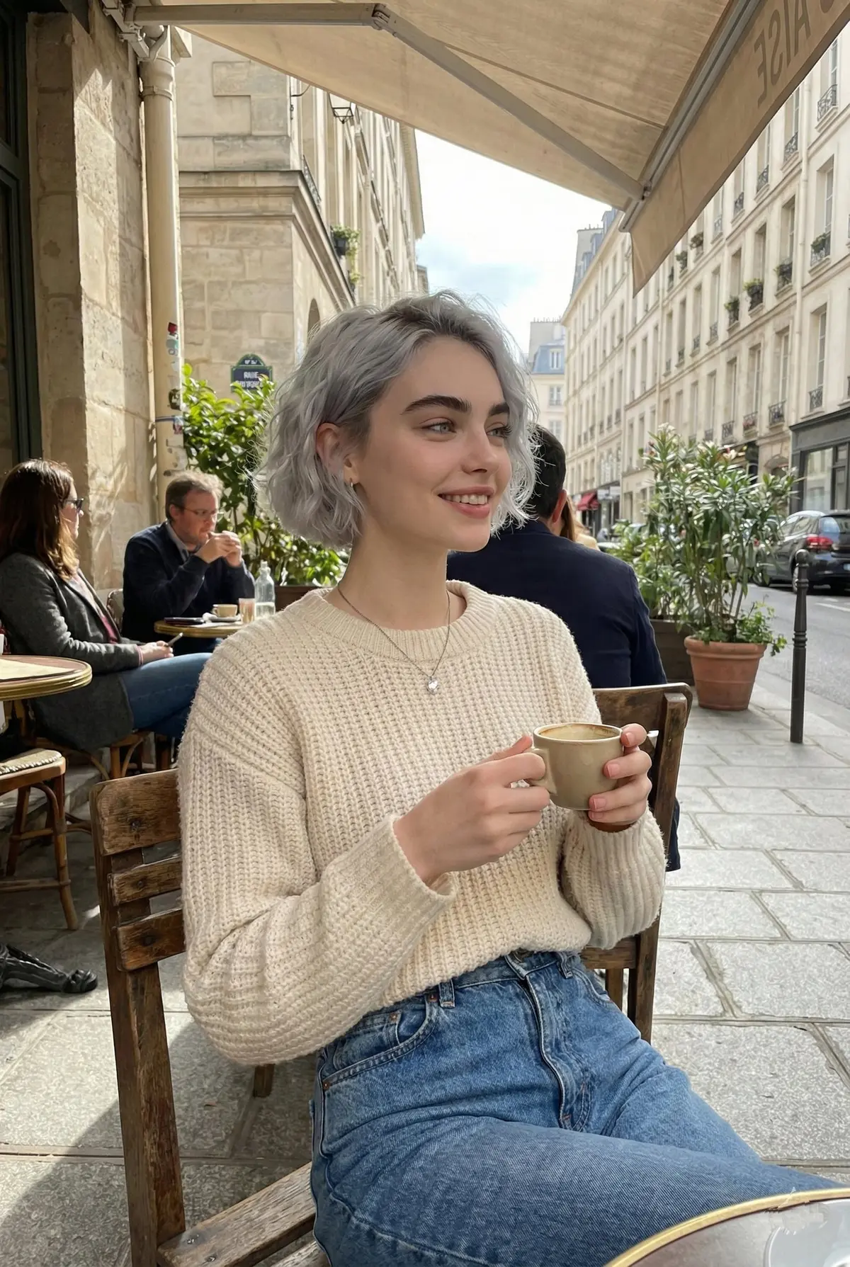A candid lifestyle portrait of a young woman sitting at an o