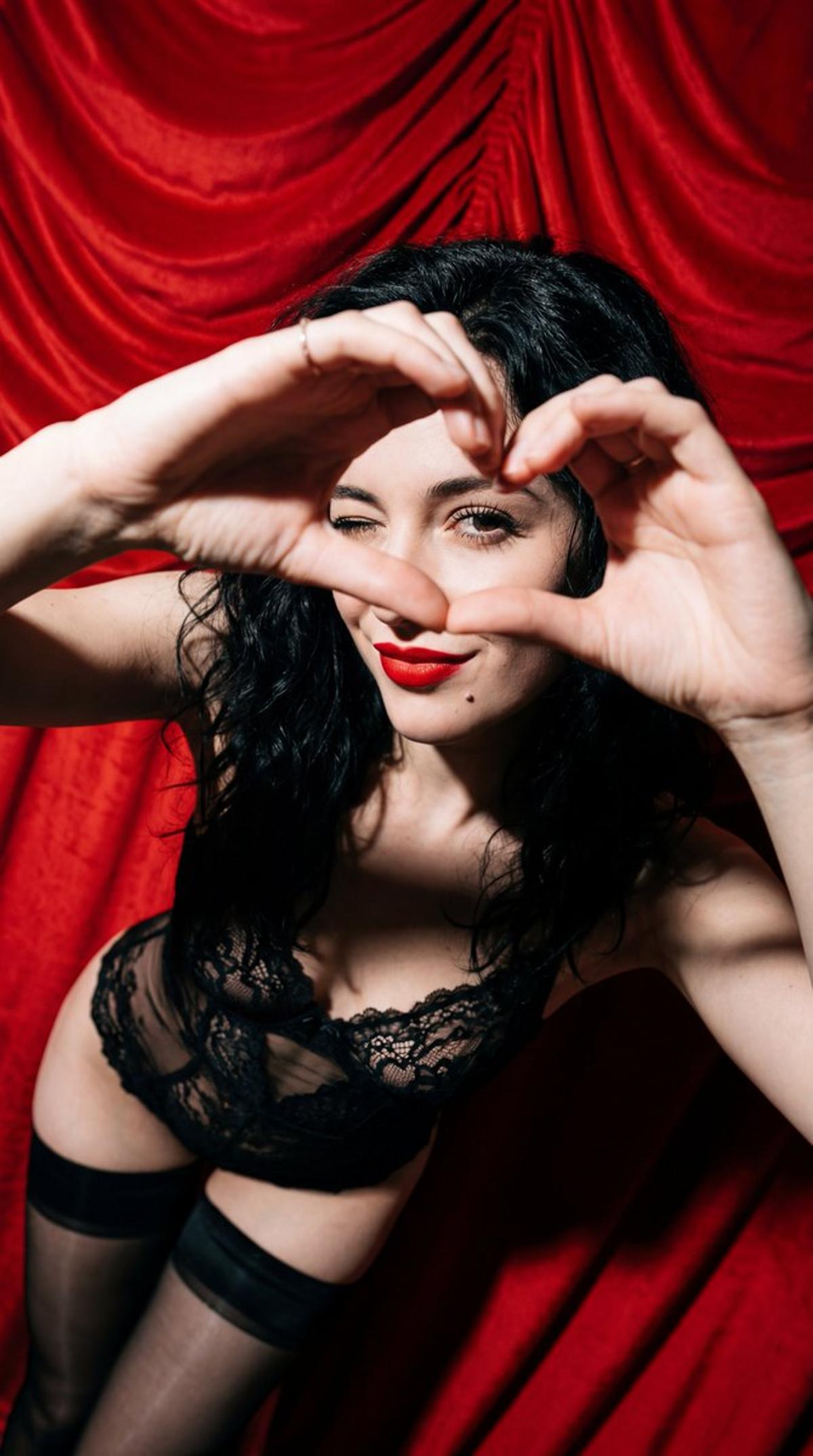 Subject: A young woman with wavy, tousled jet-black hair. Sh