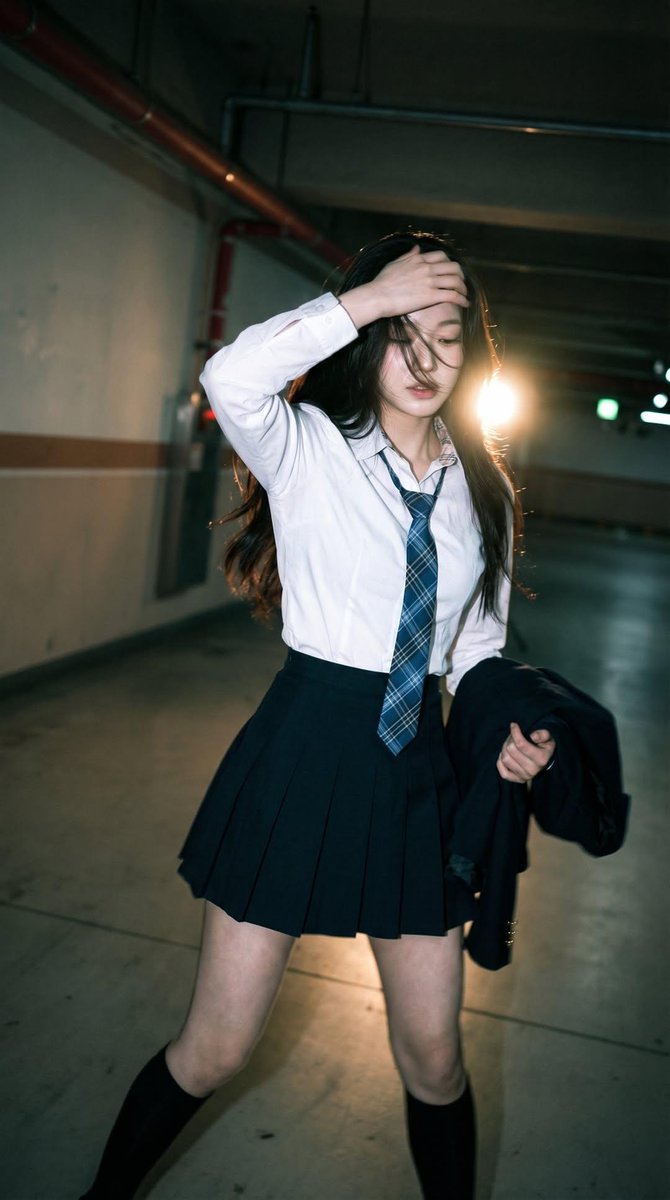 Candid portrait of a young woman in a dim parking garage, we