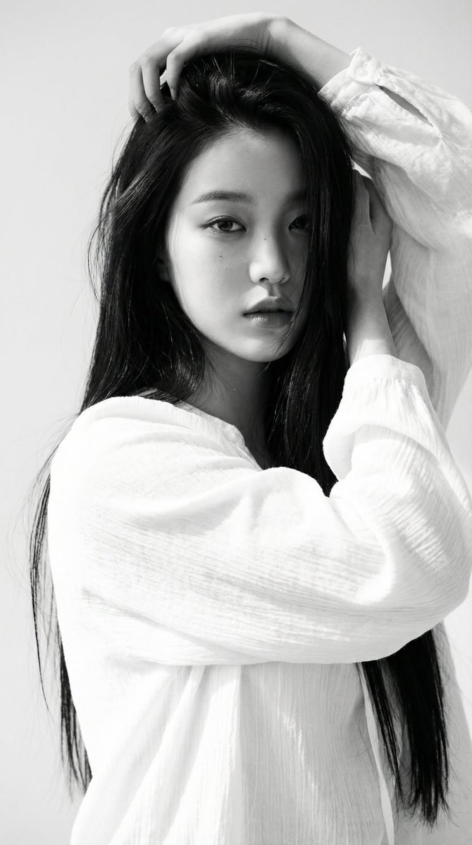 Black-and-white portrait of a young woman with long straight