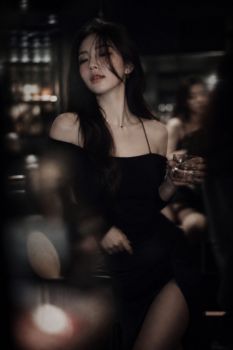 Low-light cinematic portrait, telephoto lens compression, sh