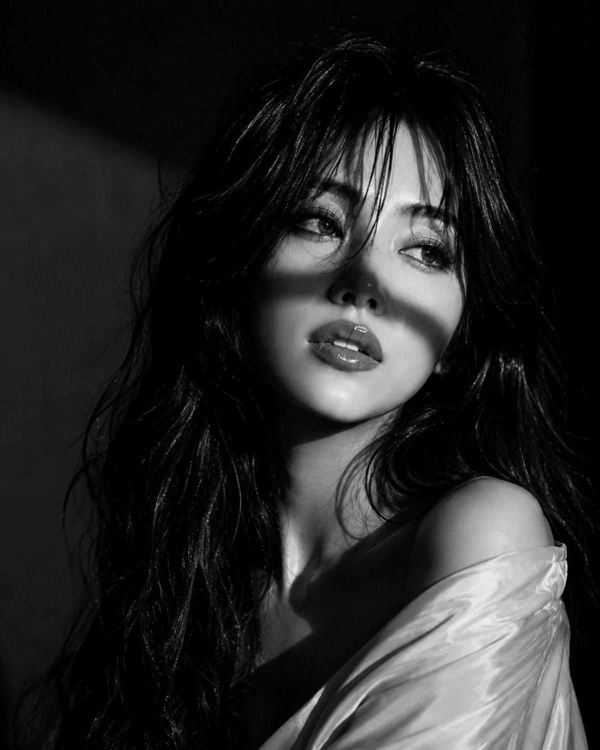 Black-and-white Vogue portrait with dramatic diagonal shadows