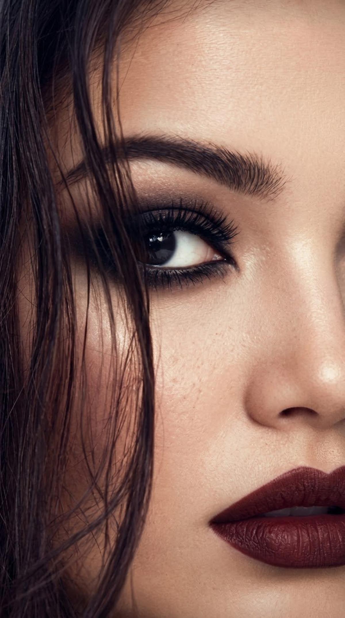 Macro smoky-eye beauty portrait with burgundy lips