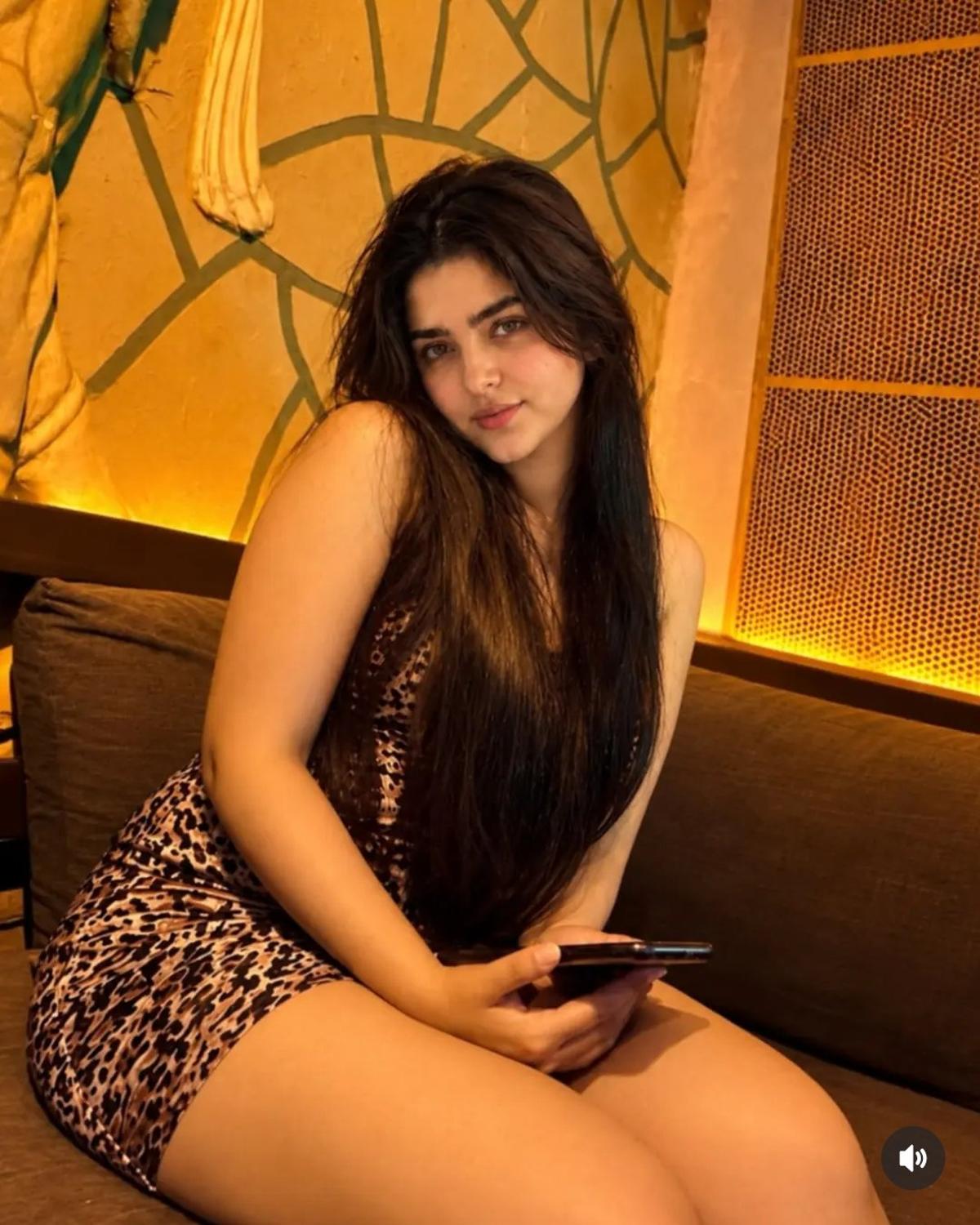 Warm restaurant portrait in a sleeveless leopard-print dress
