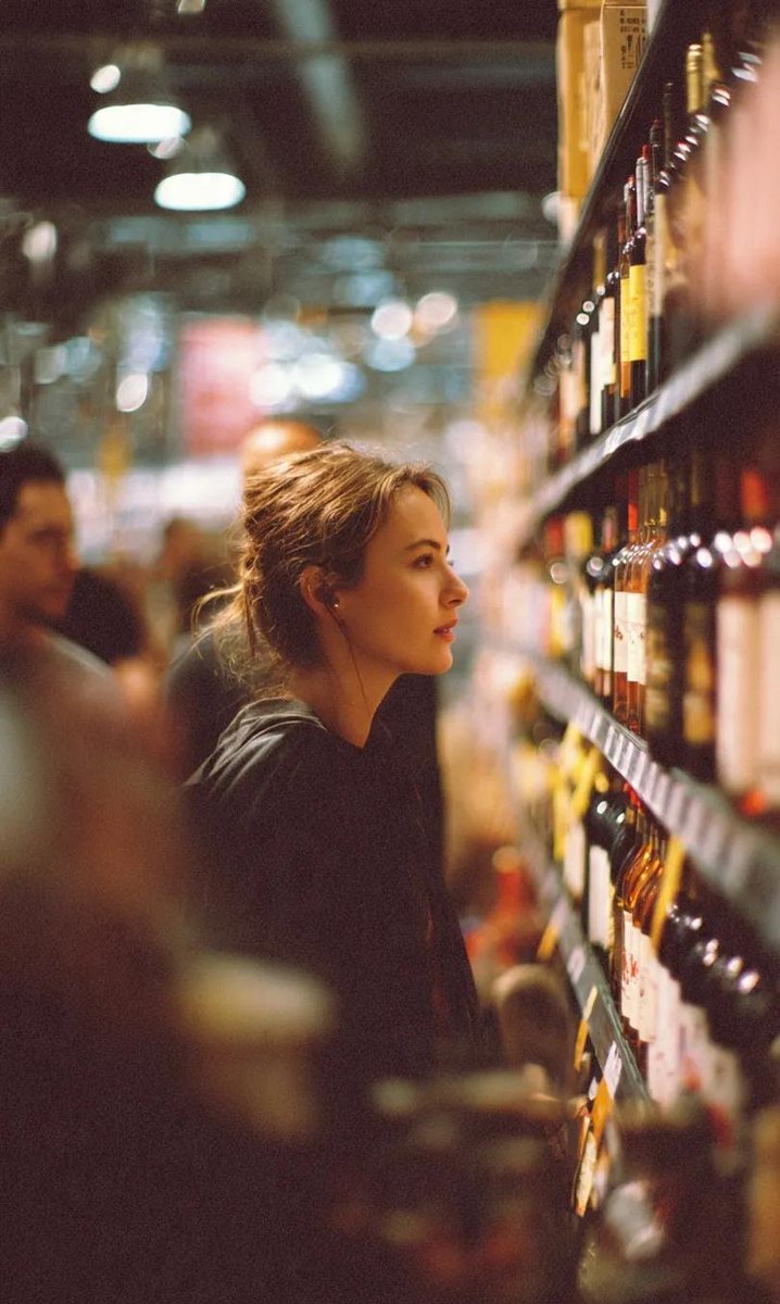 A cinematic side-profile portrait of a young woman standing 