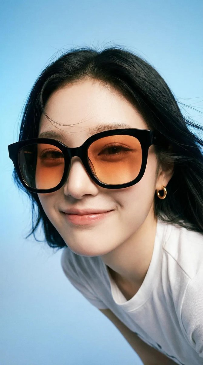 Photorealistic editorial portrait of a smiling woman using t